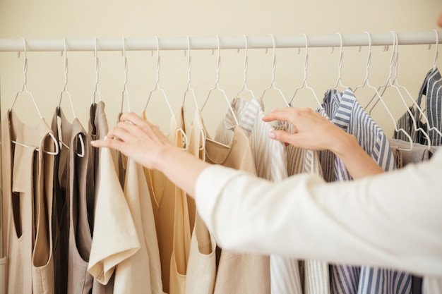 Free photo close up of clothes hanging on rack