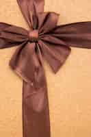 Free photo close up coffee coloured ribbon with bow