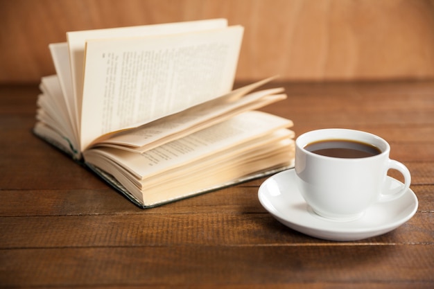 Free photo close-up of coffee cup and book