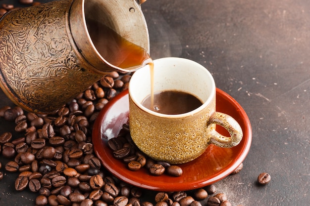 Close-up coffee cup surrounded by beans