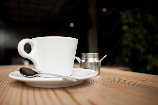 Close-up of coffee cup on table at caf�