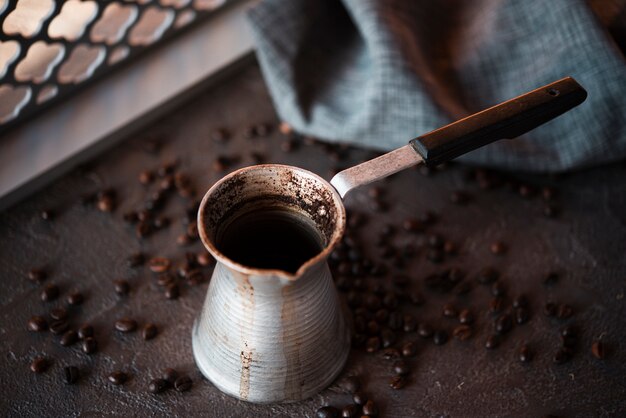 Close-up coffee kettle with roasted beans