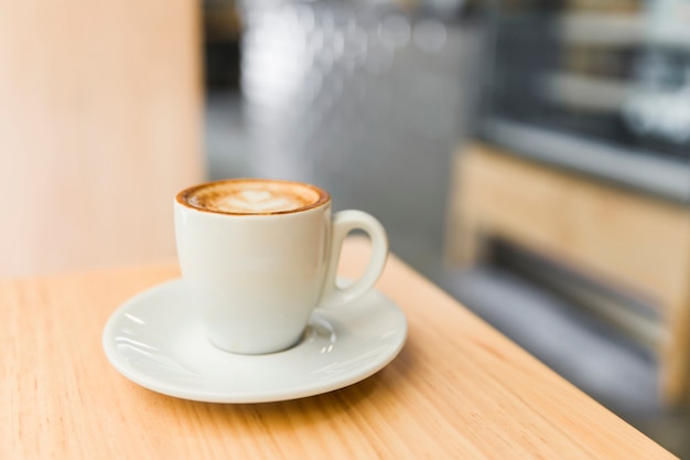 Close-up of coffee latte on wooden table