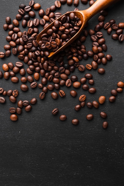 Close-up coffee scoop with beans