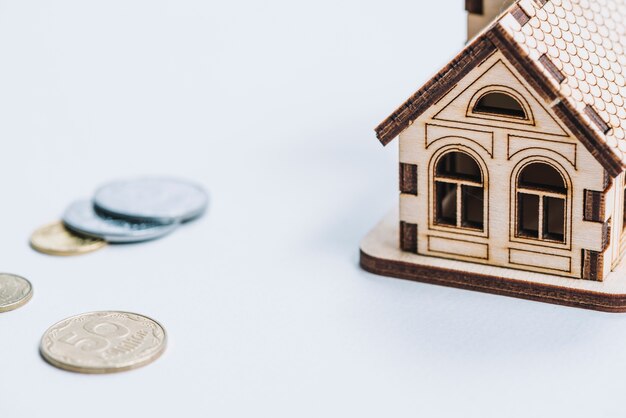 close-up coins near small house