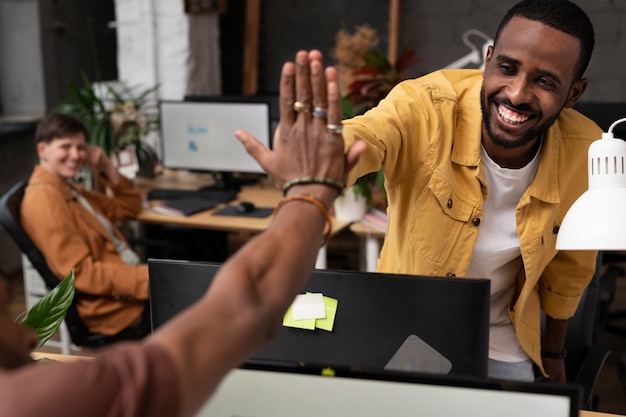 Close up colleagues high five