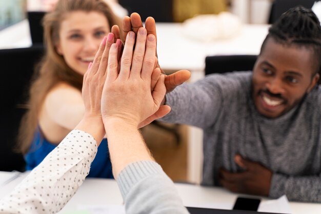 Close up colleagues high five