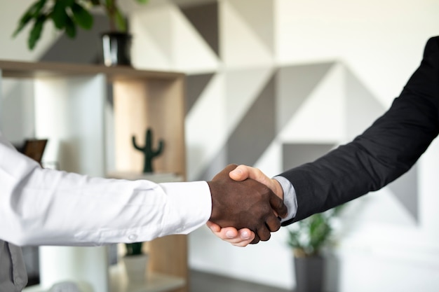 Close up of colleagues shaking hands