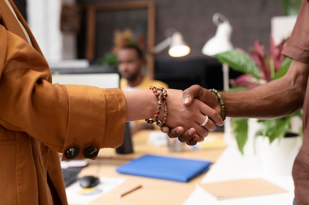 Close up colleagues shaking hands