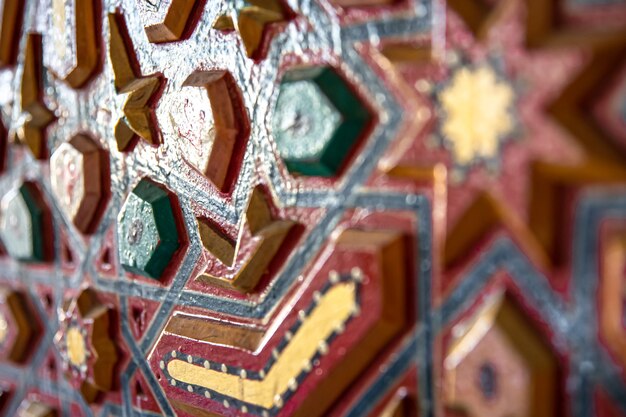 Close up of colored ornament on wood in traditional oriental style.