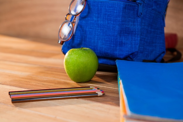 Close-up of colored pencil with apple