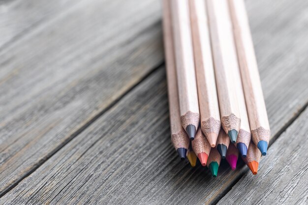 Close up of colored pencils for drawing on blurred background copy space.