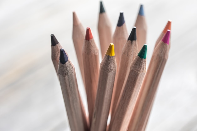 Close up of colored pencils for drawing on blurred background