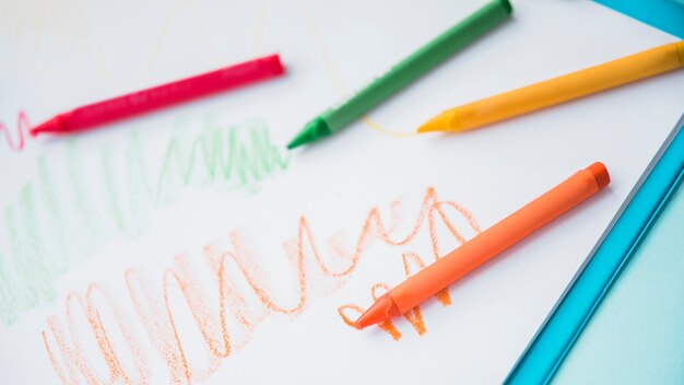 Close-up of colorful crayon on white paper