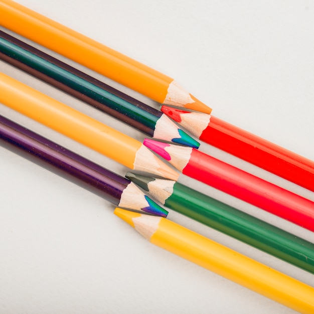 Close-up of colorful drawing pencils isolated on white backdrop