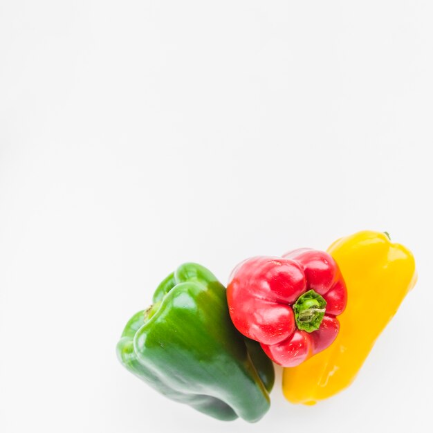 Close-up of colorful fresh bell peppers on white background
