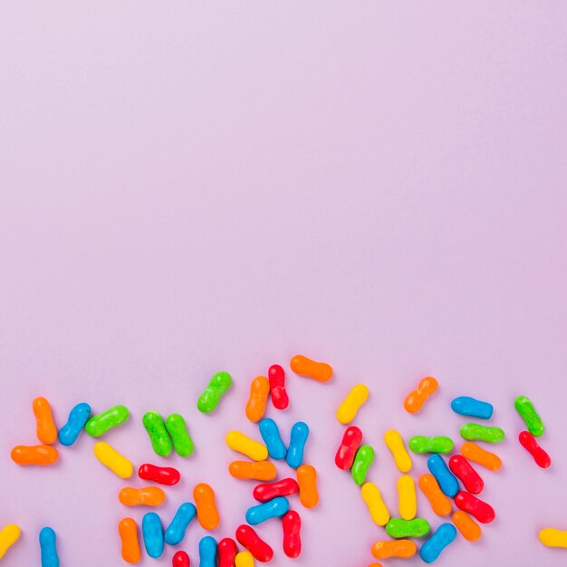 Close-up of colorful marmalade candies over the pink background