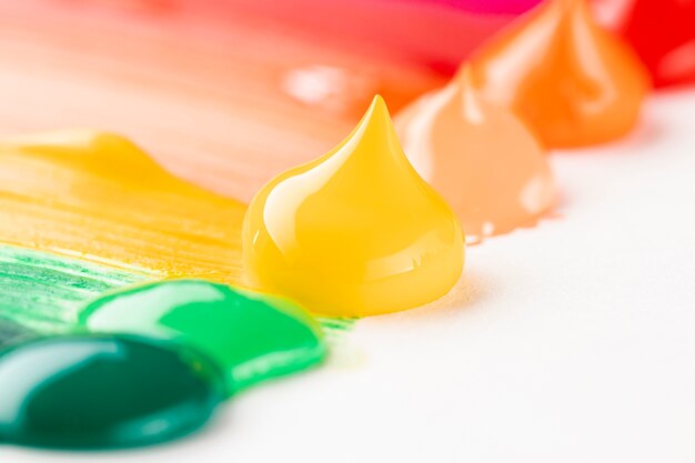 Close-up of colorful paint on white table