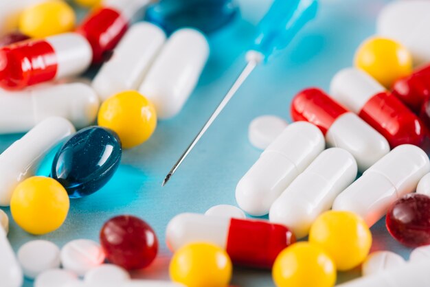 Close up of colorful pills and syringe