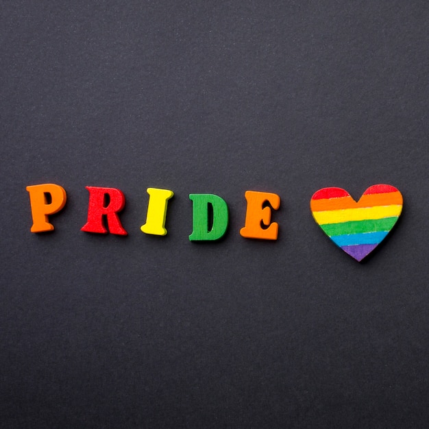 Free photo close-up colourful pride word and heart