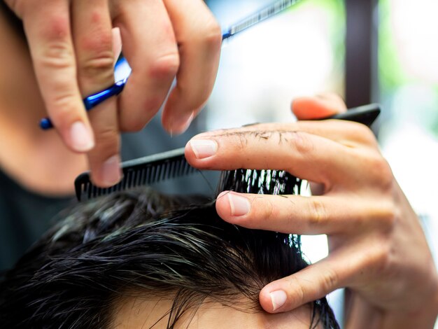 Free photo close-up of comb and scissors in hands