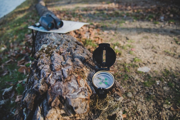 Close-up of compass on a fallen log