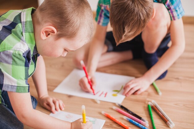 Close-up of concentrated children drawing