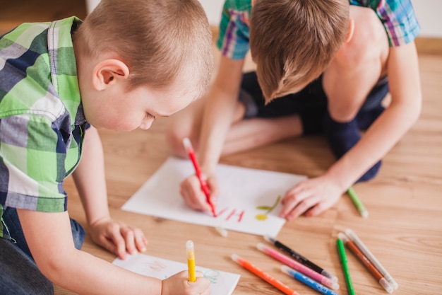 Close-up of concentrated children drawing