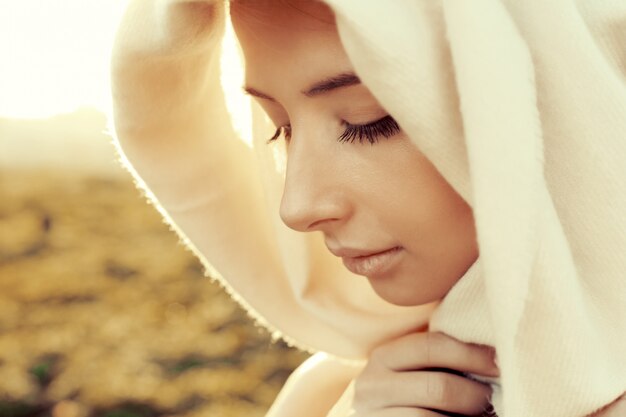 Close-up of concentrated young woman with a handkerchief