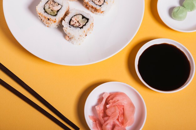 Close-up condiments near sushi