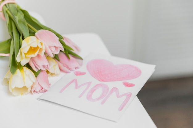 Close-up of congratulation greeting card with bunch of tulip flowers