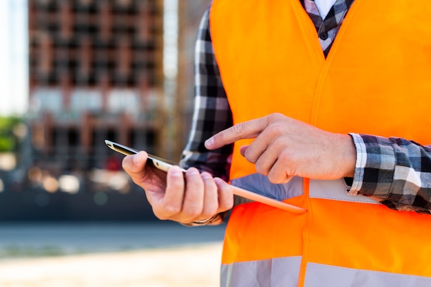 Close-up construction engineer using tablet