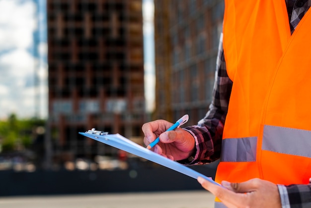 Close-up construction engineer writing