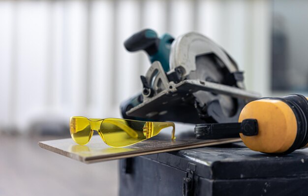 Close up of construction safety goggles and work tools