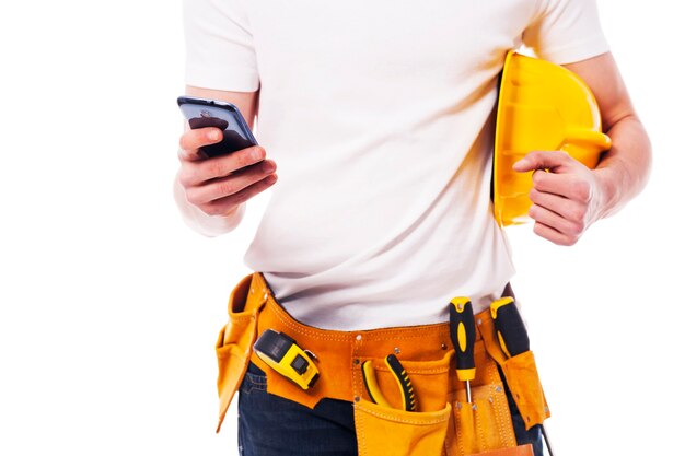 Close-up of construction worker using a mobile phone