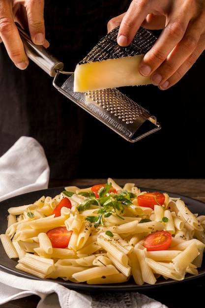 Free photo close-up cook grating cheese