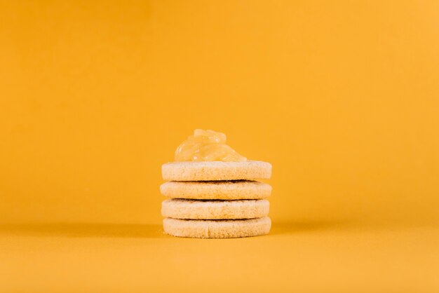 Close-up of cookies with lemon curd on yellow background