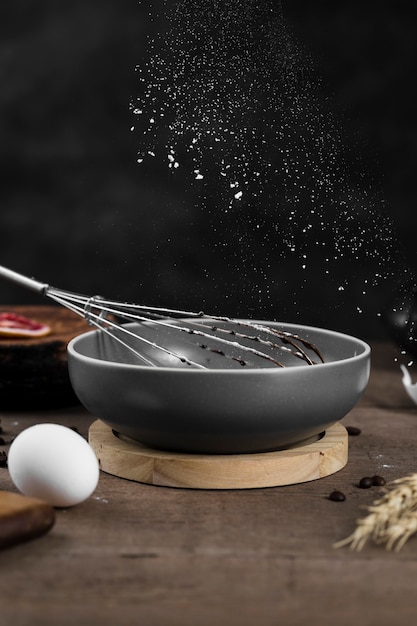 Close-up cooking pan with whisk on the table