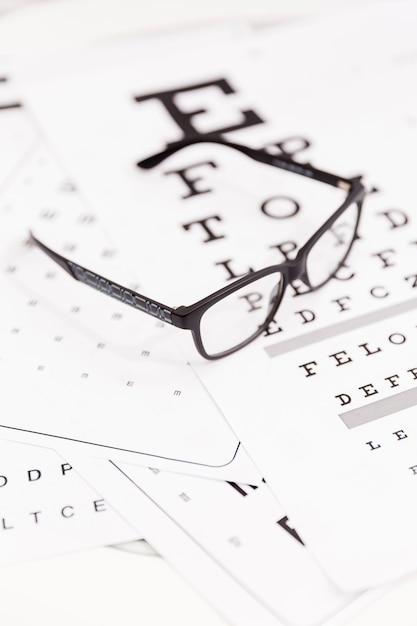 Close-up of corrective spectacle on snellen chart