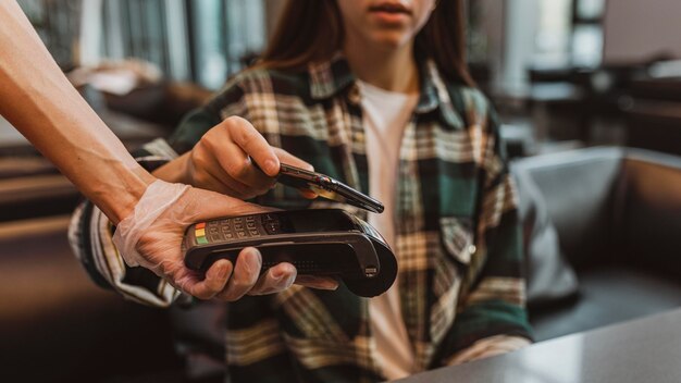 Close up of a costumer paying for coffee