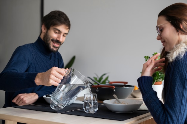 Free photo close up couple eating at home