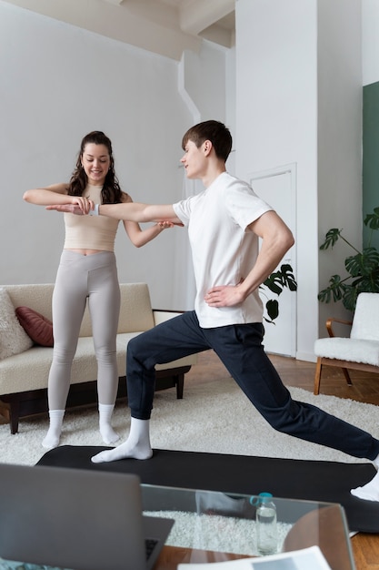 Close up on couple exercising after online instructor