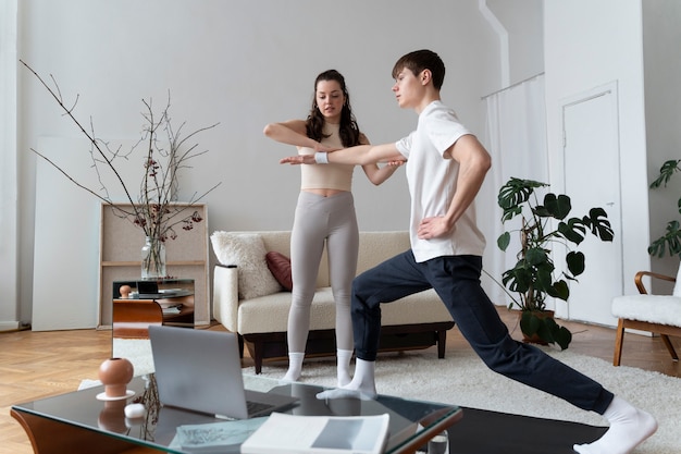 Free photo close up on couple exercising after online instructor