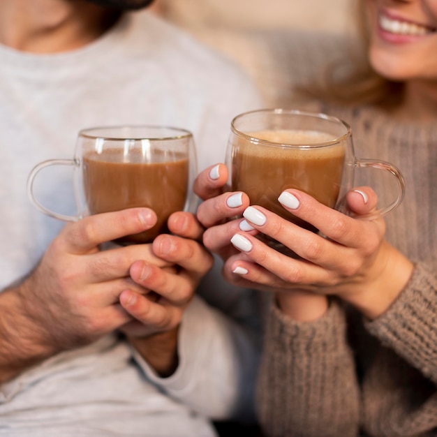 Close-up couple holding drinks