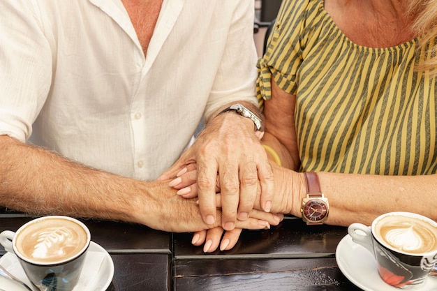 close-up couple holding hands together