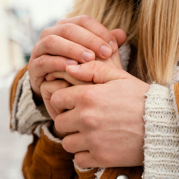 Close up couple holding hands