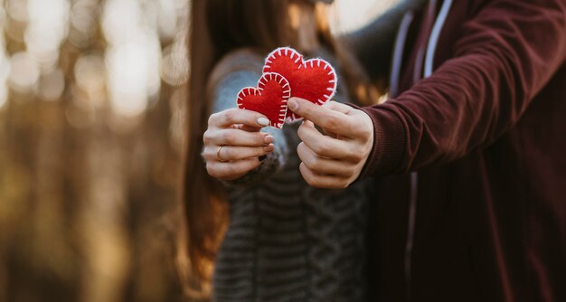 Close-up couple holding little hearts