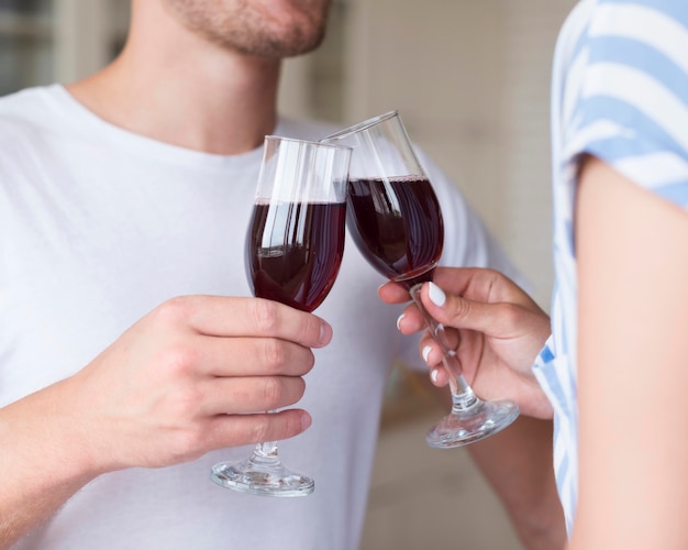Close-up couple holding wine glasses