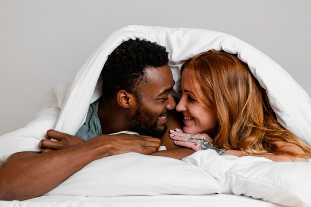 Close-up couple laying in bed