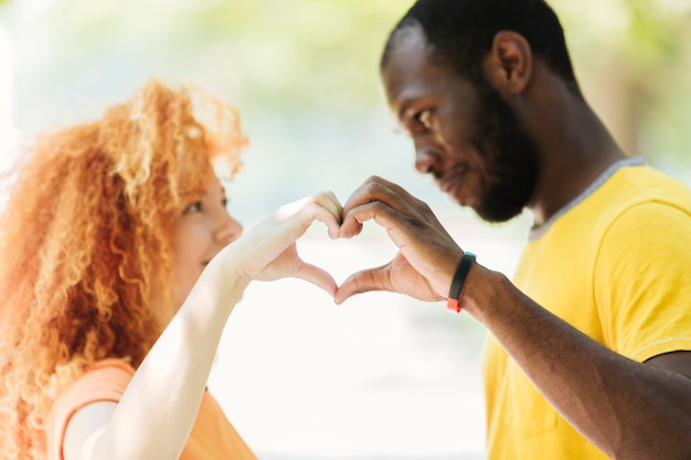 Free photo close-up of couple making a heart